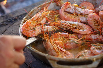 Fototapeta na wymiar Very tasty large prawns in sauce with lemon and garlic close-up