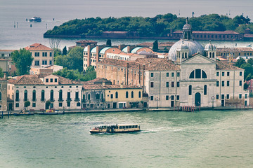 Aerial view of lone vaporetto (public transportation) cruises through the Grand Canal in Venice,...