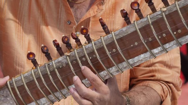Hands of Indian musician playing Sitar shot in slow motion 180 fps.