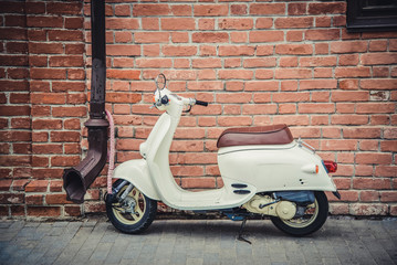 Scooter at the red brick wall