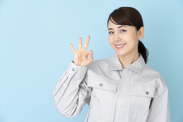 portrait of asian engineer woman on blue background