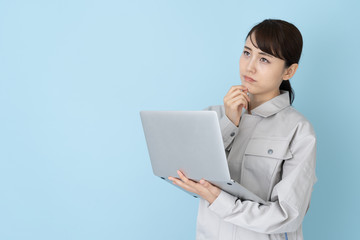 portrait of asian engineer woman on blue background