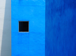 Small window on a blue building.