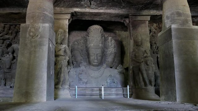 Mumbai, India:4K footage of Elephanta cave interior Trimurti sculpture, on Elephanta island near Mumbai. This is one of the UNESCO World heritage Site.	