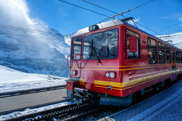 Naklejka premium A red Swiss train at a station in Switzerland