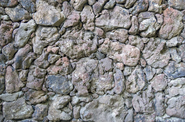 Wall of colorful volcanic  stone  closeup