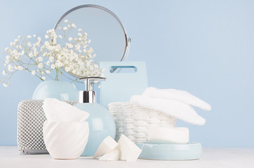 Modern soft light interior for bathroom - pastel blue ceramic bowls, flowers, mirror, silver...