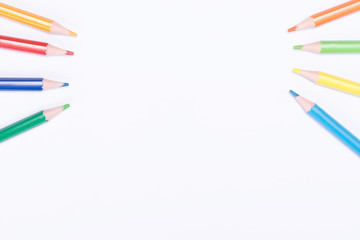 colored pencils left and right on a light background