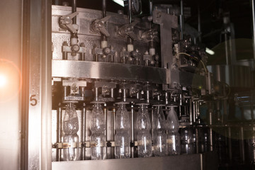 Water bottles on production line. Bottling mineral water into small bottles