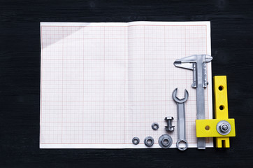 Graph paper for project drafts and a different construction tools on the builder table....