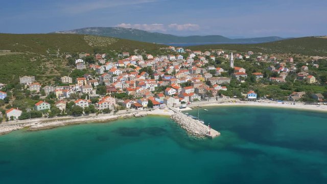 Aerial - Coastline town with turquoise colored water