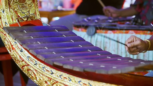 Thai classical music instrument : Hands hitting the Thai wooden alto xylophone instrument