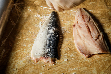 cook hand in glove prepare raw mackerel fillet