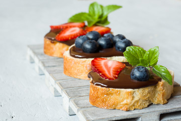 Toast bread with chocolate spread and berries strawberries blueb