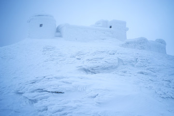 Observatory on a mountain peak in the snow