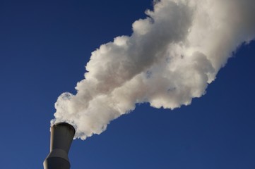 White smoke coming out of industrial chimney