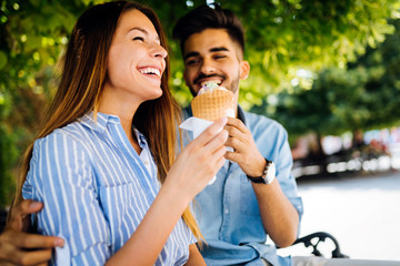 Happy couple having date and eating ice cream