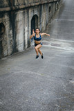 Female athlete training leg power running on a ramp