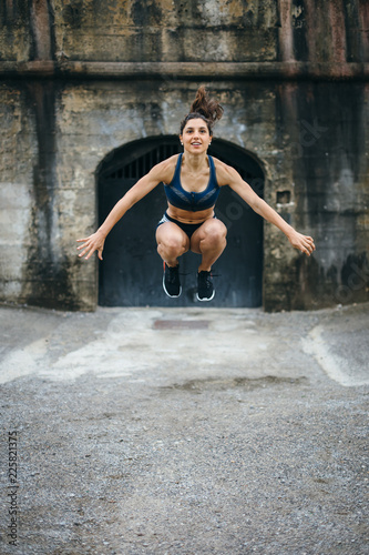 Female athlete doing tuck jumps