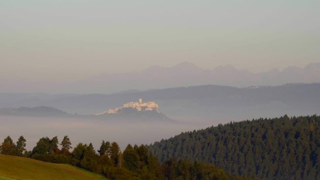 Early morning shot of Spis Castle surrounded with morning fog/mist in autumn time.