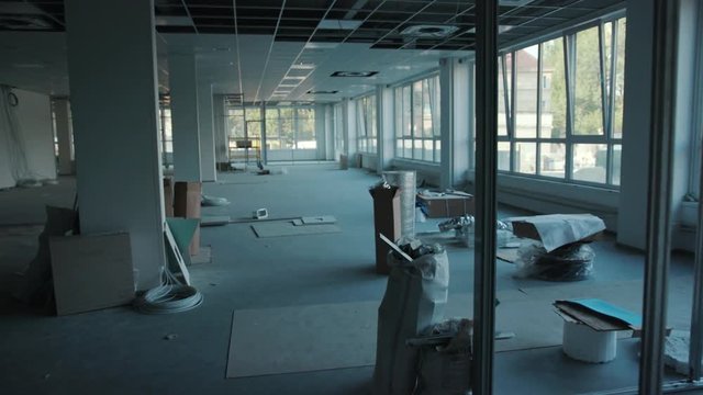 The office is in repair white walls light burning building materials builder building construction contractor engineer industrial male renovation technician development design project slow motion