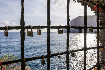 Padlocks hanging from a window on the sea, with promises of eternal love, Monterosso al mare, La Spezia, Liguria, Italy