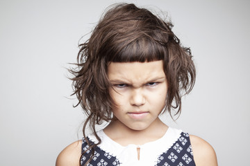 Little angry girl with stylish haircut