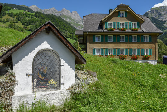 Chapel and traditional chalet at Engelberg on Switzerland