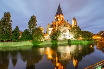 Night view on the riverside with basilica in Metz city, France