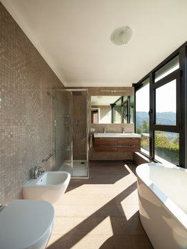 Modern wooden bathroom with large windows