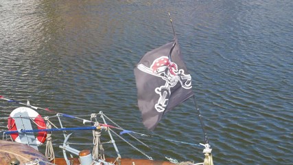 Pirate flag flapping in the wind in Whitby, England.