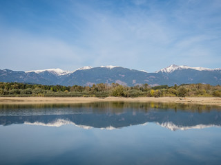 The lake with clear turquoise water is surrounded by mountains. Liptovska Mara Slovakia. The concept of ecological and active tourism. Autumn in nature.