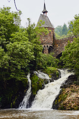 Fototapeta na wymiar Medieval tower, bridge and waterfall