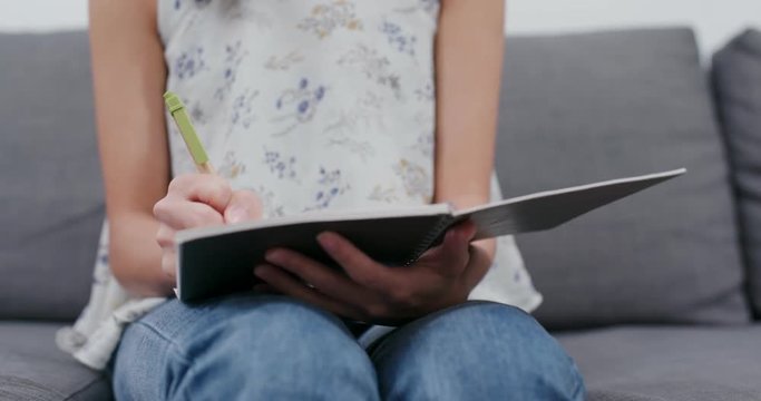Woman jot down on notebook