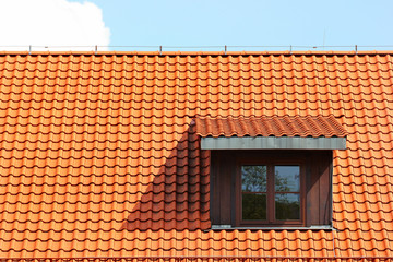 Attic window in orange tiled roof