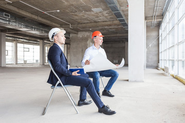 men engineers builders working at the table with a laptop, business negotiations at the...