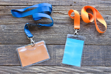 Two vip id cards with tags on wooden background