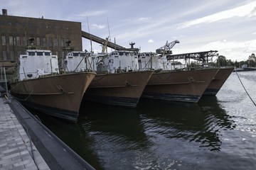 discarded military ship moored at the harbor
