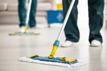 Fotobehang Close-up on mop on the floor holding by cleaning specialist while purifying interior © Photographee.eu