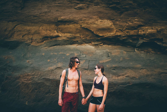 Couple posing against rock face, Canoa, Manabi, Ecuador