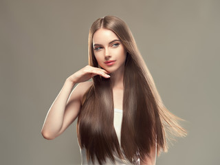 Woman with long brunette smooth hair shine and beauty hairstyle