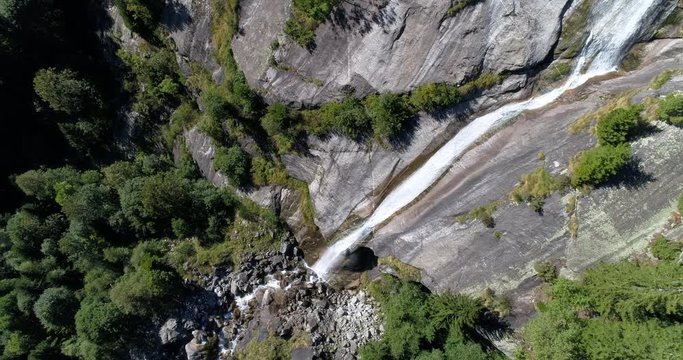 Waterfall on rock wall. Natural park of the Val di Mello, Valtellina, Italian Alps. This valley is famous for sport climbing. Aerial shot made with drone.