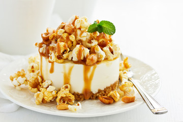 A delicious New York chocolate cheesecake with popcorn and caramel. close-up.