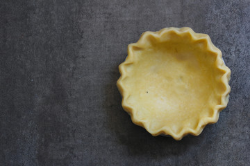 An empty raw uncooked Pie crust before baking with copy space, top view