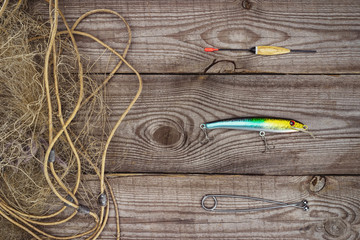 view from above of fishing float, bait and fishing net on wooden planks © LIGHTFIELD STUDIOS