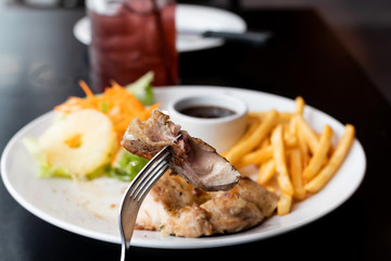 chicken steak with French fries and sauce on table
