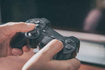 Woman plays video game using the gamepad © Monika Wisniewska