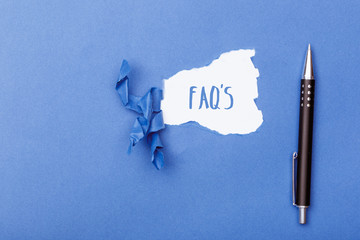 FAQs written on Ripped piece of paper