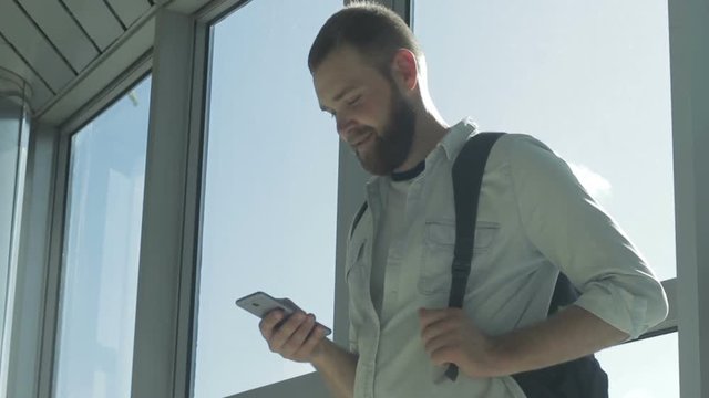 Optimistic young bearded hipster undergreduate fellow receiving good information