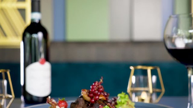Zoom in on grilled steack beef meat on a plate with sweet berries